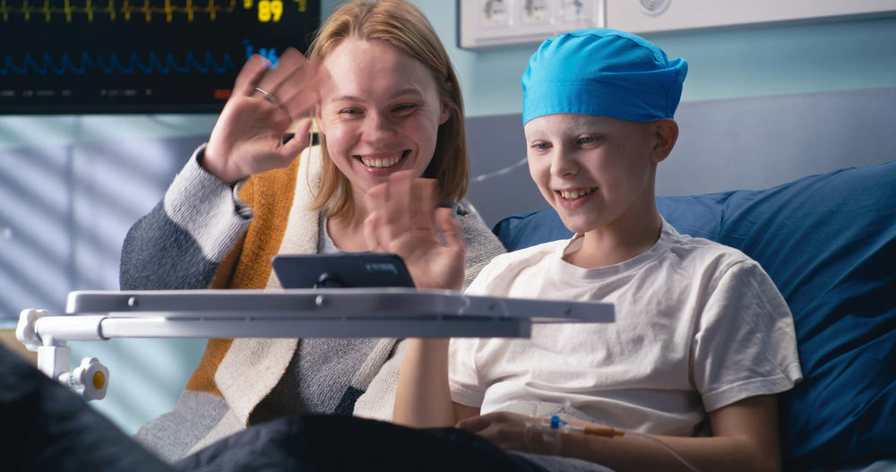 Happy mother and son making video call from clinic